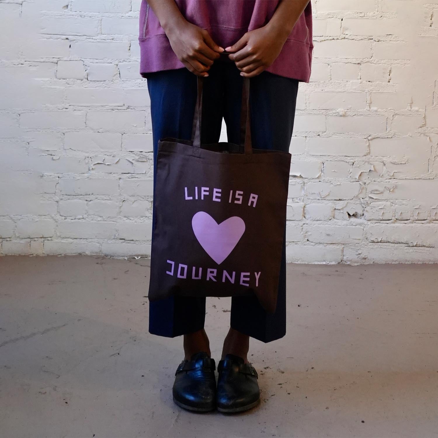 Lightweight brown canvas tote bag with Life is a Journey graphic