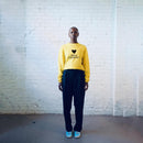 Model wearing a bright yellow sweatshirt with "Life is a Journey" graphic printed on the front.