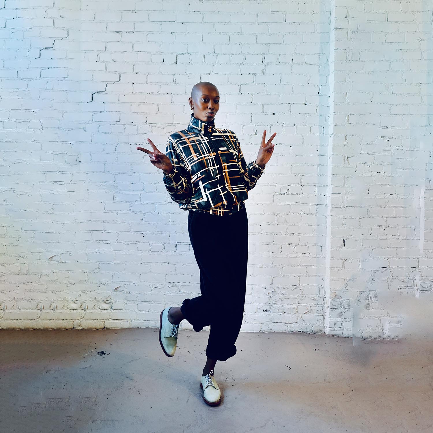 Model wearing a vintage silk bomber jacket with multi-square pattern.