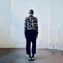 Model wearing a vintage silk bomber jacket with multi-square pattern.