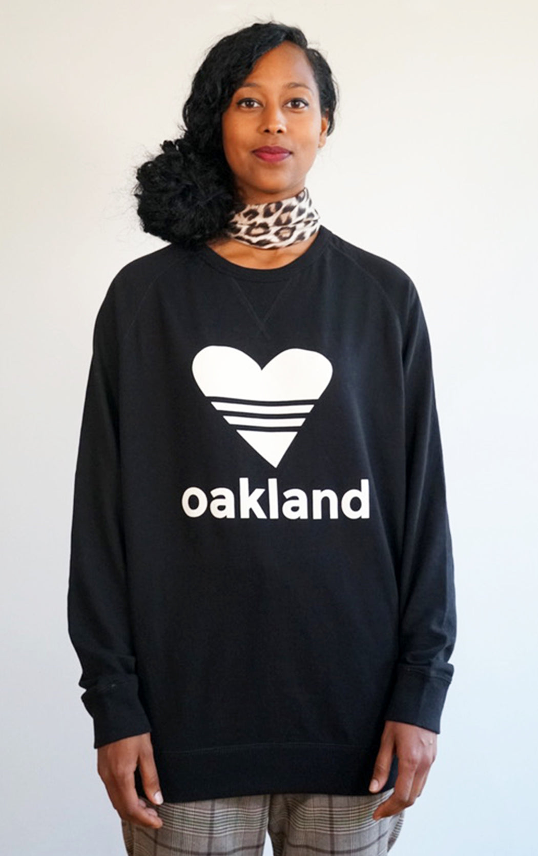 black super soft love oakland sweatshirt in a cool crew neck style made in a soft cotton blend with love oakland heart graphic on front 